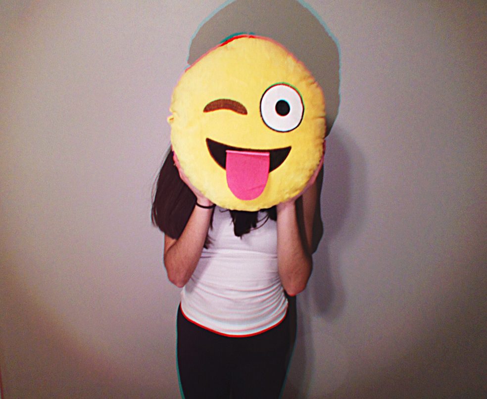Person holding a smiley pillow